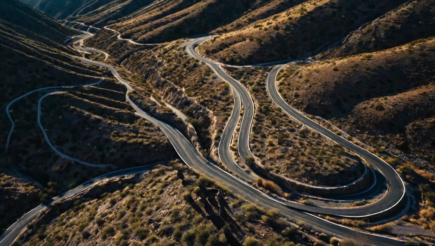 Aerial view of winding mountain road with switchbacks